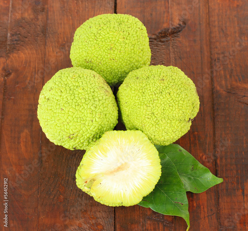 Osage Orange fruits (Maclura pomifera), on wooden background photo