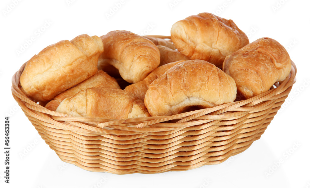 Tasty croissants in wicker basket isolated on white