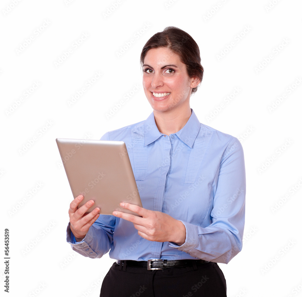 Charming young woman standing using tablet pc Charming young woman standing using tablet pc