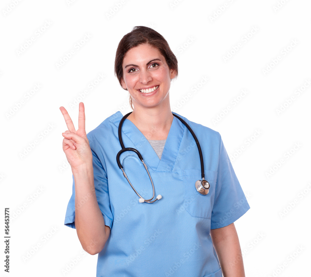 Lovely female nurse with victory finger sign Lovely female nurse with victory finger sign