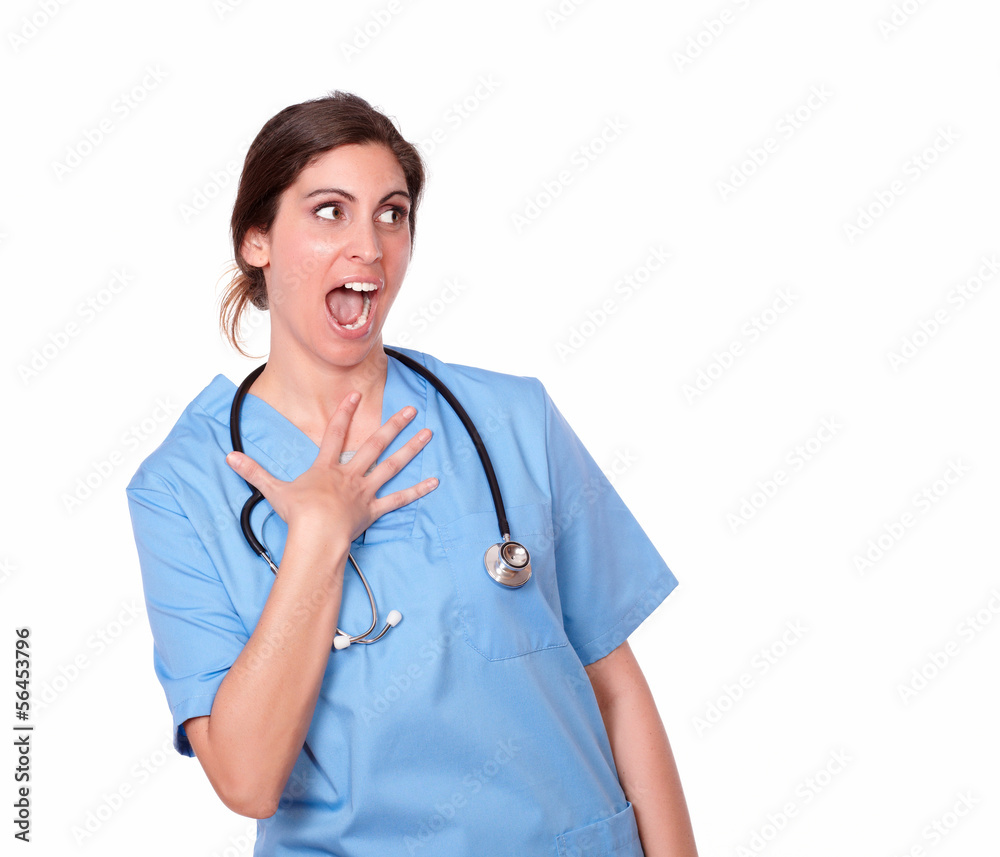 Attractive lady nurse in blue looking surprised Attractive lady nurse in blue looking surprised
