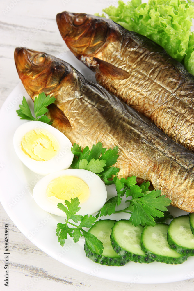 Smoked fish on plate close up