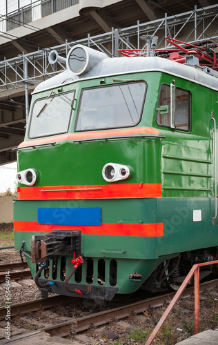 Green locomotive with red stripes on the cabin