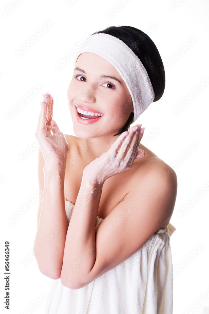 Happy woman is cleaning her face Happy woman is cleaning her face