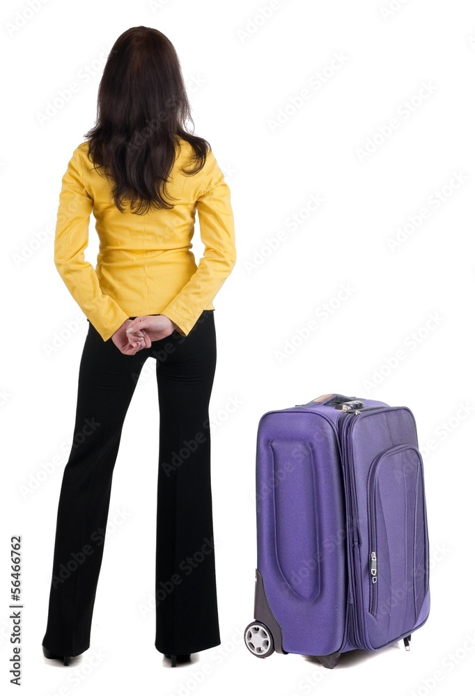 traveling young woman with suitcas in yellow suit looking at w traveling young woman with suitcas in yellow suit looking at w