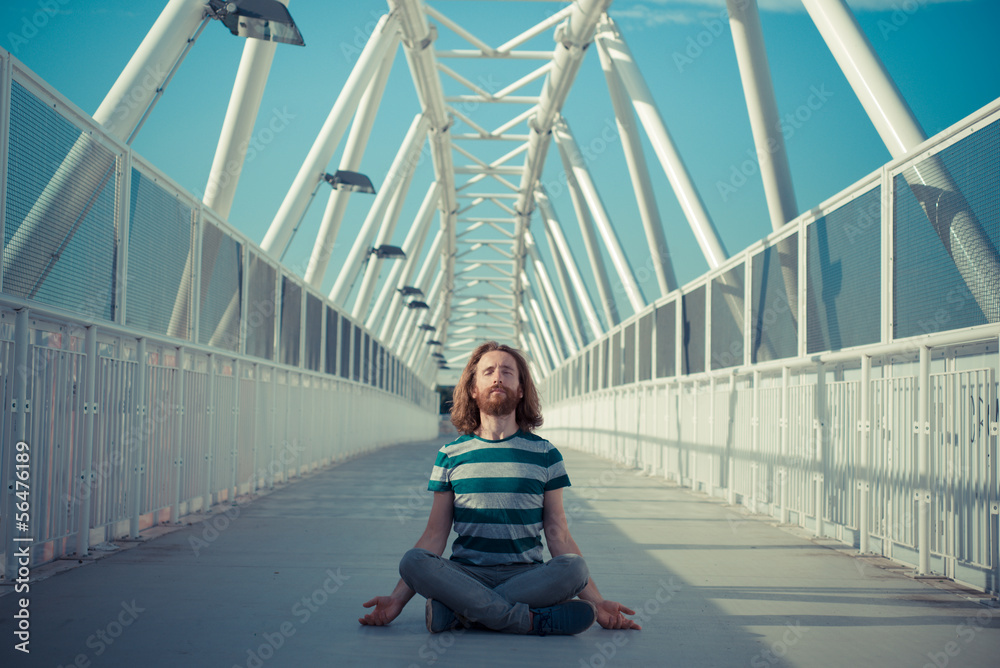 stylish hipster model with long red hair and beard yoga
