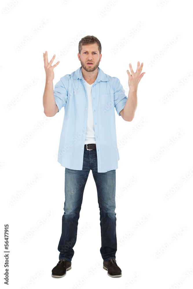 Handsome man posing with hands up and looking at camera Handsome man posing with hands up and looking at camera