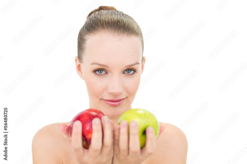 Cute blonde model offering two apples Cute blonde model offering two apples