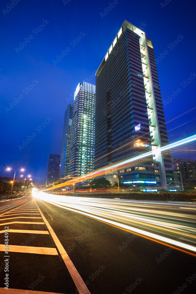 Night traffic trails on the  cityscape background