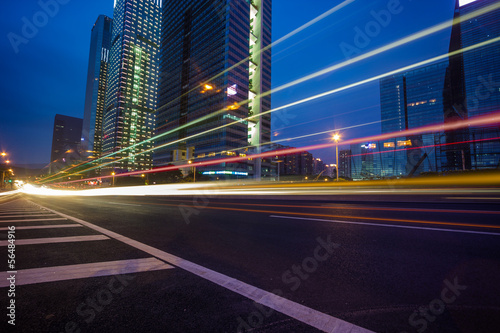Night traffic trails on the cityscape background