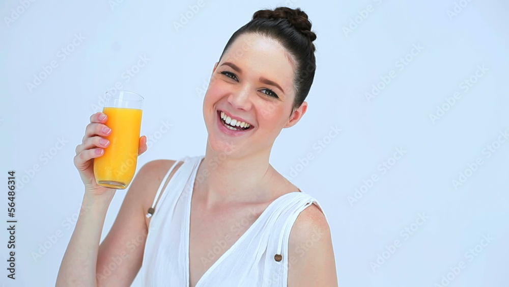 Beautiful woman holding a glass of orange juice Beautiful woman holding a glass of orange juice