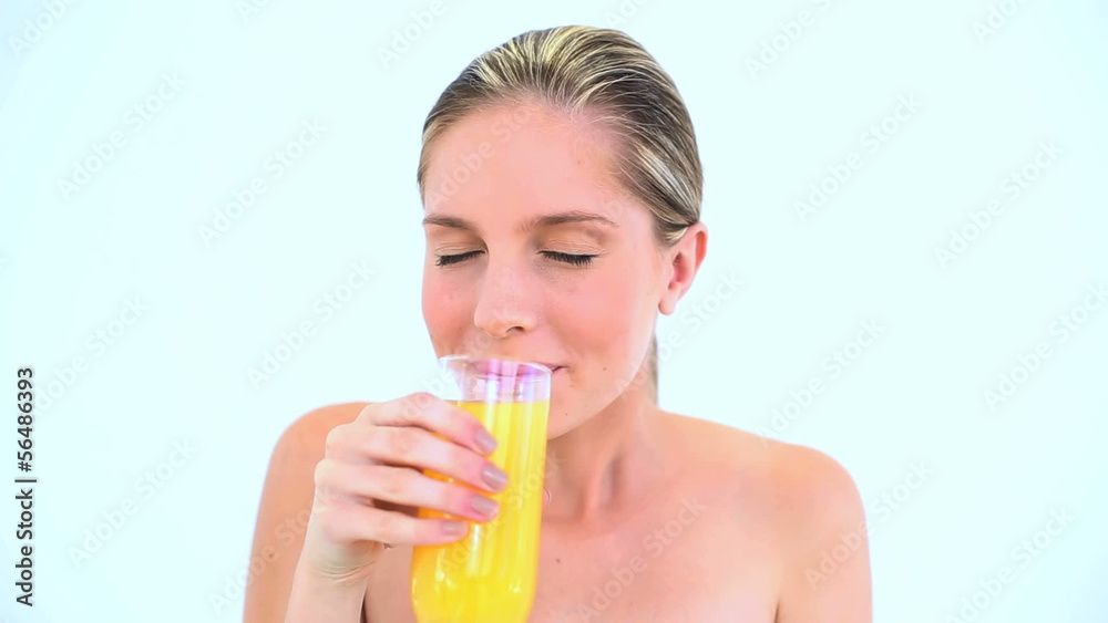 Blond woman holding a glass of orange juice Blond woman holding a glass of orange juice