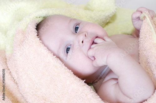 baby age of 4 months in towel after bath