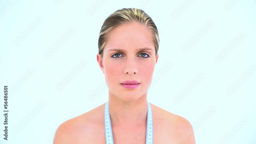 Troubled woman with a measuring tape around her neck Troubled woman with a measuring tape around her neck
