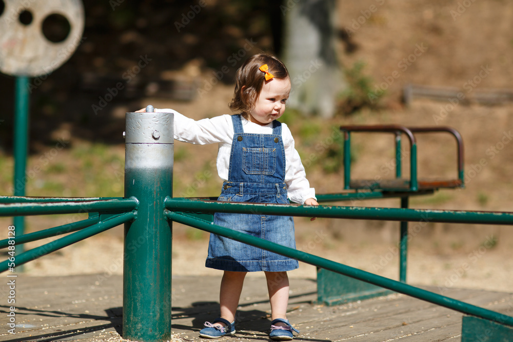 Fototapeta premium Little cute baby girl having fun in park, summer