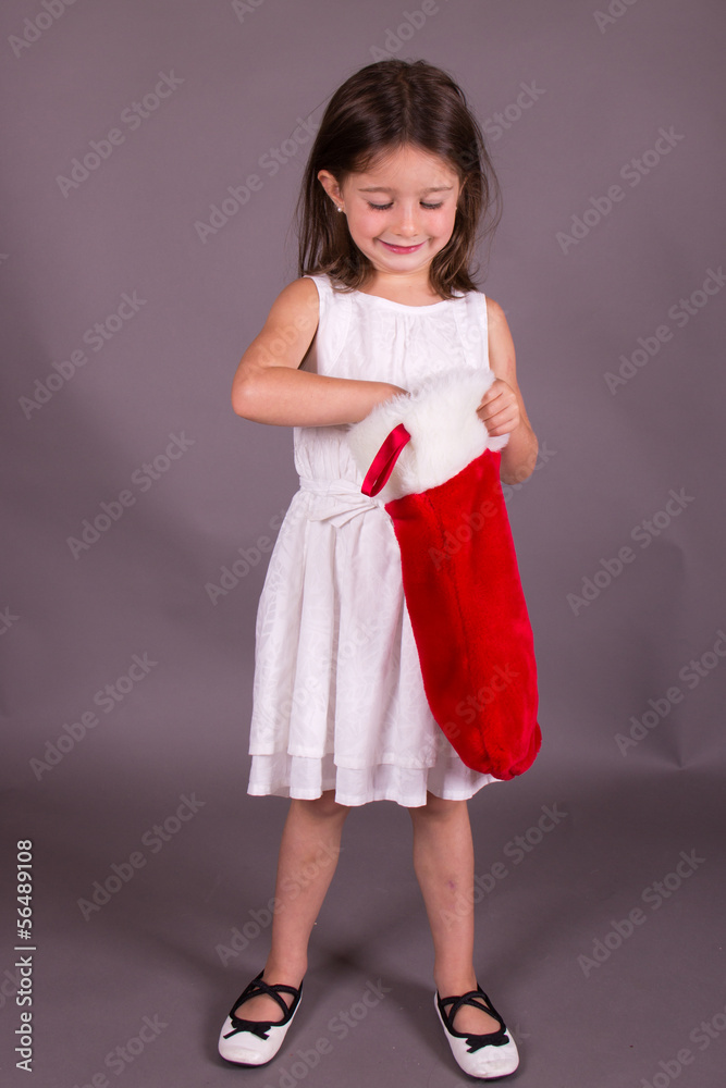 Little girl with Christmas stocking Little girl with Christmas stocking