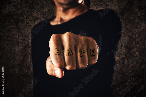 Hand with clenched fist - tattooed hate
