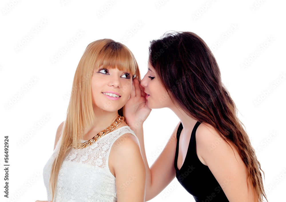 Two teen sisters whispering Two teen sisters whispering