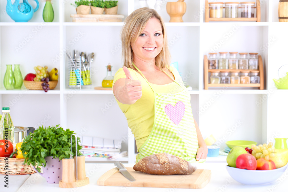 Happy smiling woman in kitchen preparing for healthy meal Happy smiling woman in kitchen preparing for healthy meal