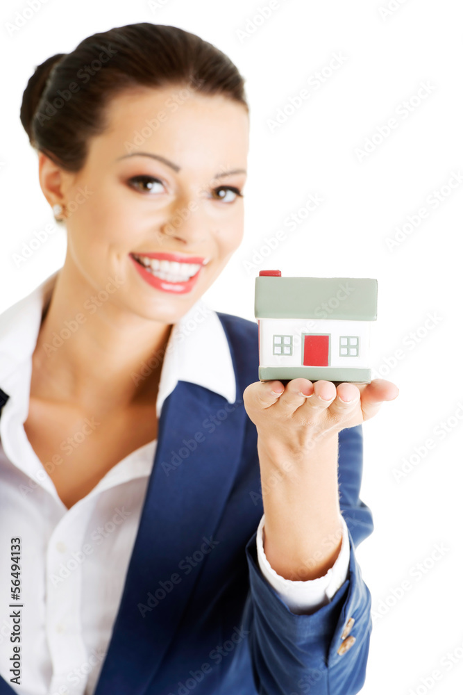 Female businesswoman holding and protecting house. Female businesswoman holding and protecting house.
