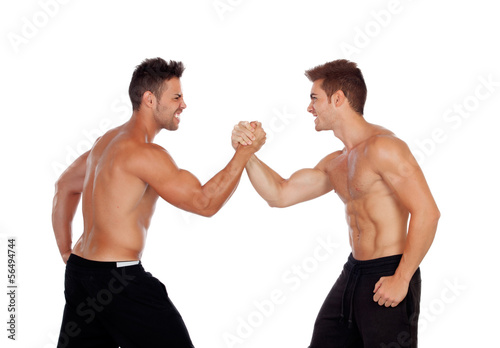 Couple of handsome muscled men competing