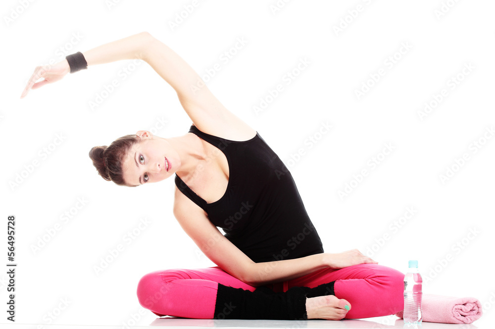 Fototapeta premium beautiful young brunette woman stretching muscles arms isolated
