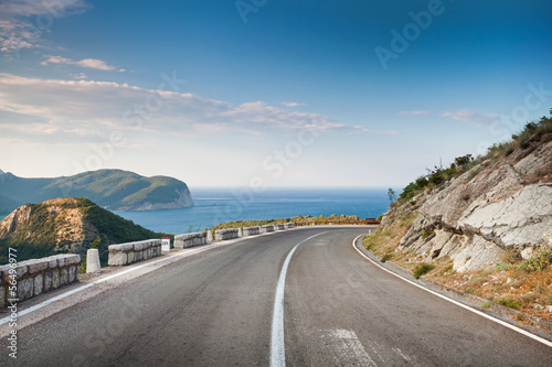 Right turn of mountain highway with blue sky