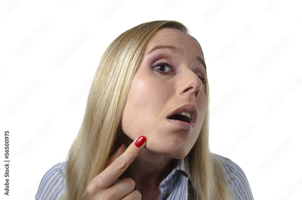 woman checking her skin for imperfections woman checking her skin for imperfections