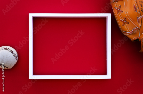 Photography empty picture frame on a red wall with baseball equipment