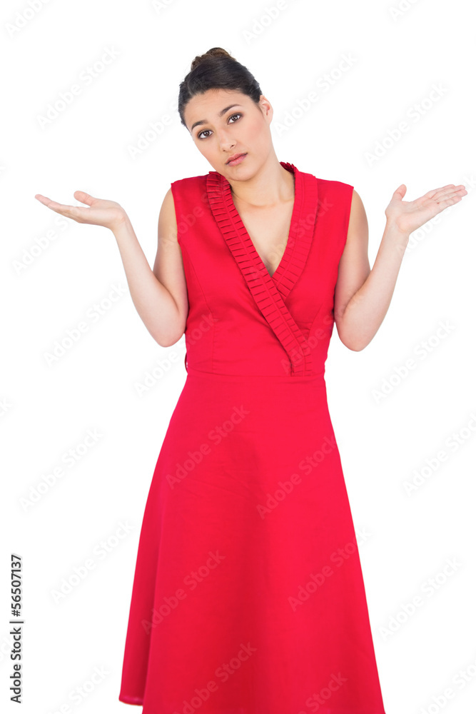 Hesitant elegant brunette in red dress posing Hesitant elegant brunette in red dress posing