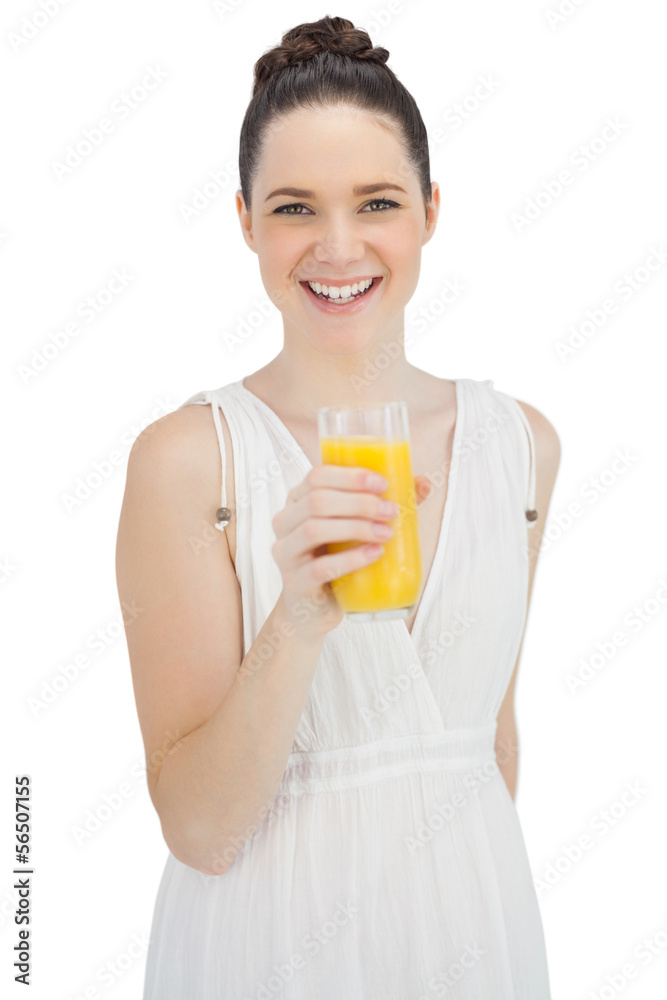 Cheerful model in white dress holding glass of orange juice Cheerful model in white dress holding glass of orange juice
