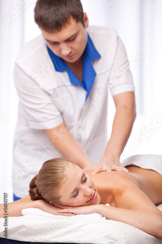 Masseur is massaging female