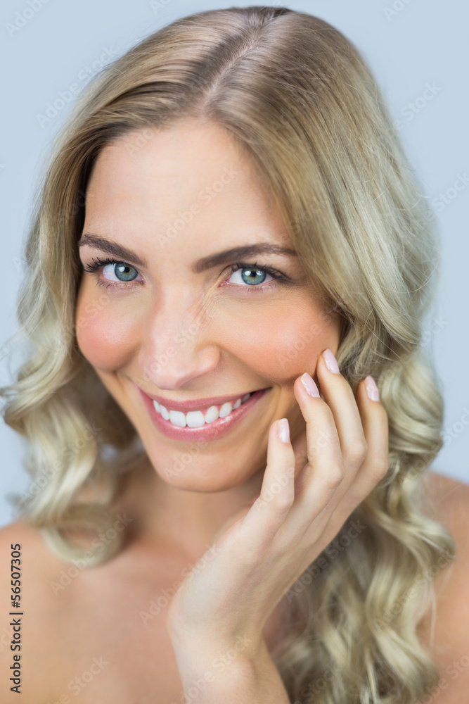 Fototapeta premium Smiling natural blonde posing touching her face