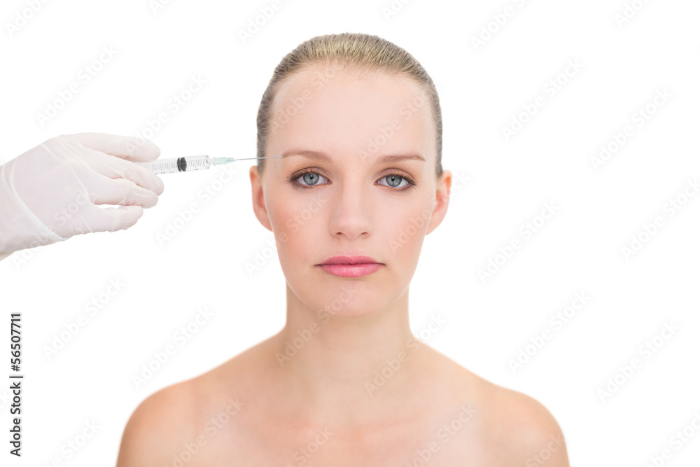 Stern pretty blonde model receiving botox injection