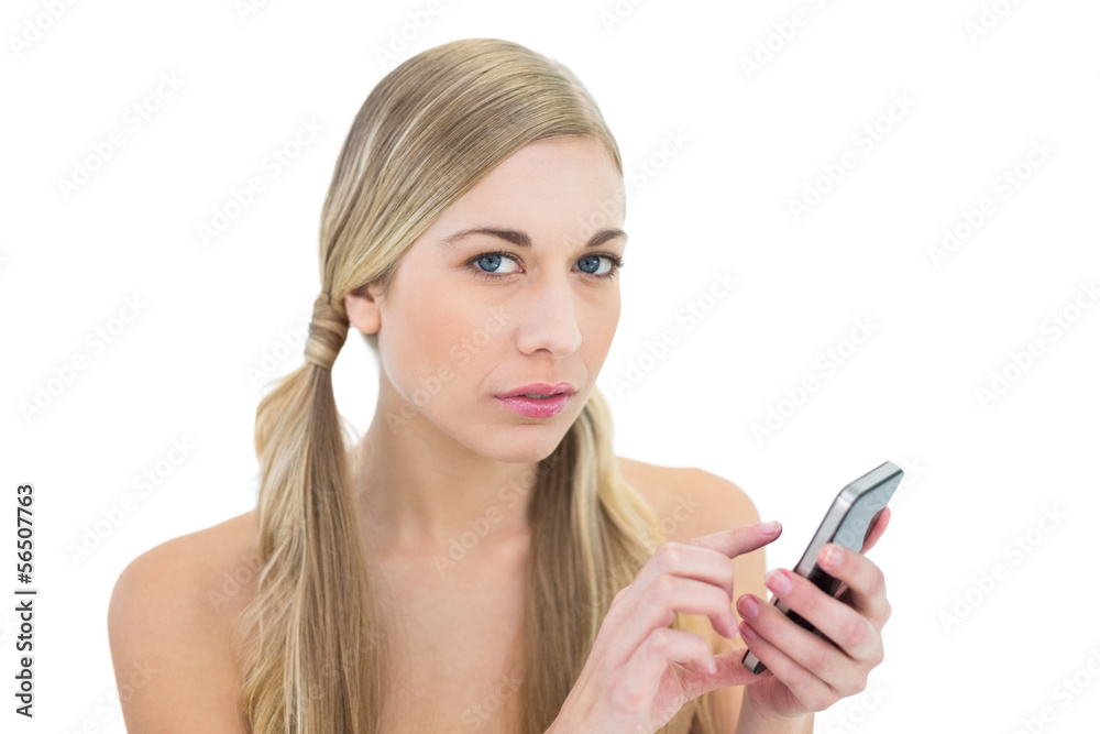 Serious young blonde woman using a mobile phone Serious young blonde woman using a mobile phone