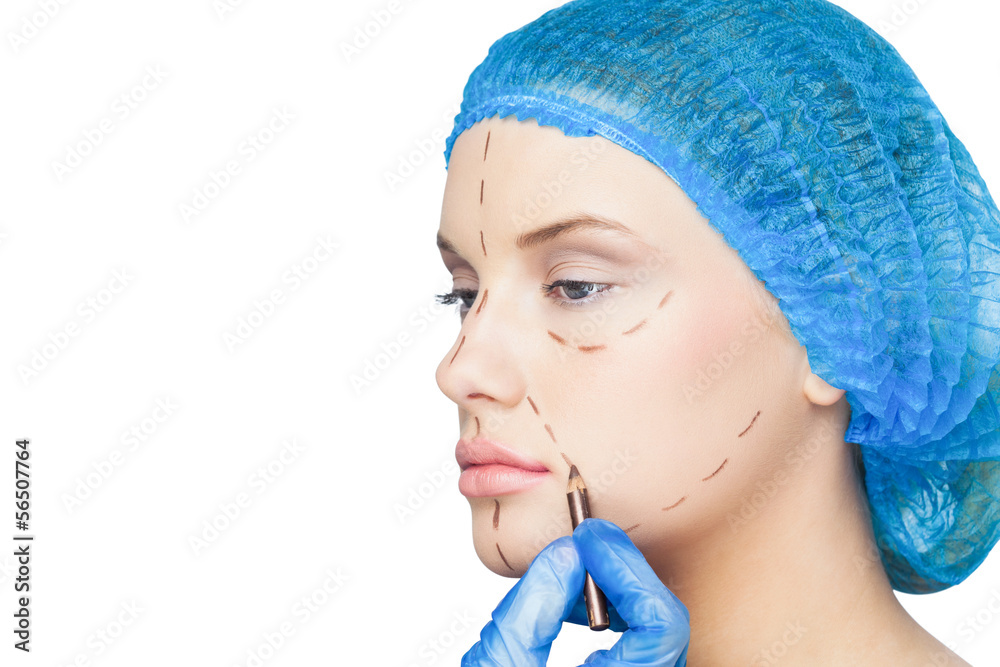 Surgeon drawing dotted lines on relaxed patient Surgeon drawing dotted lines on relaxed patient