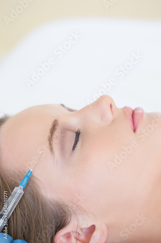 Surgeon making injection on peaceful woman lying