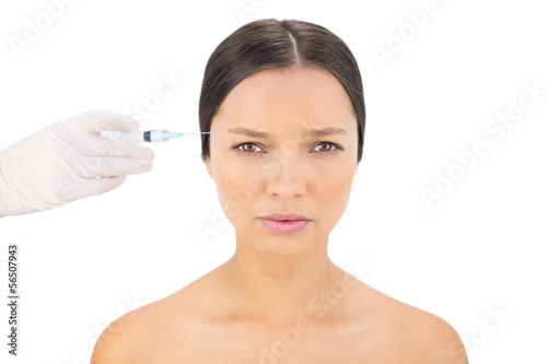 Serious bare model having botox injection