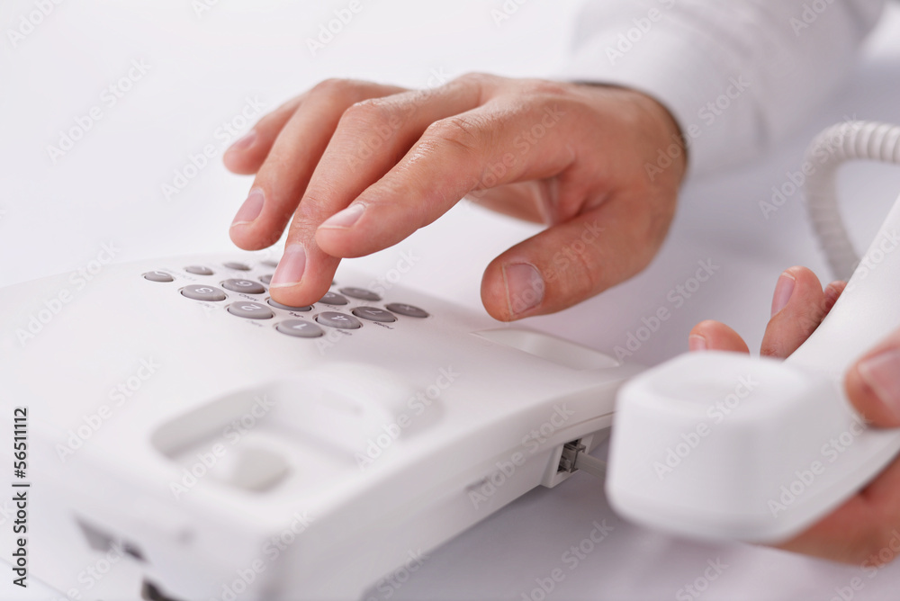 Man making a telephone call on a landline Man making a telephone call on a landline