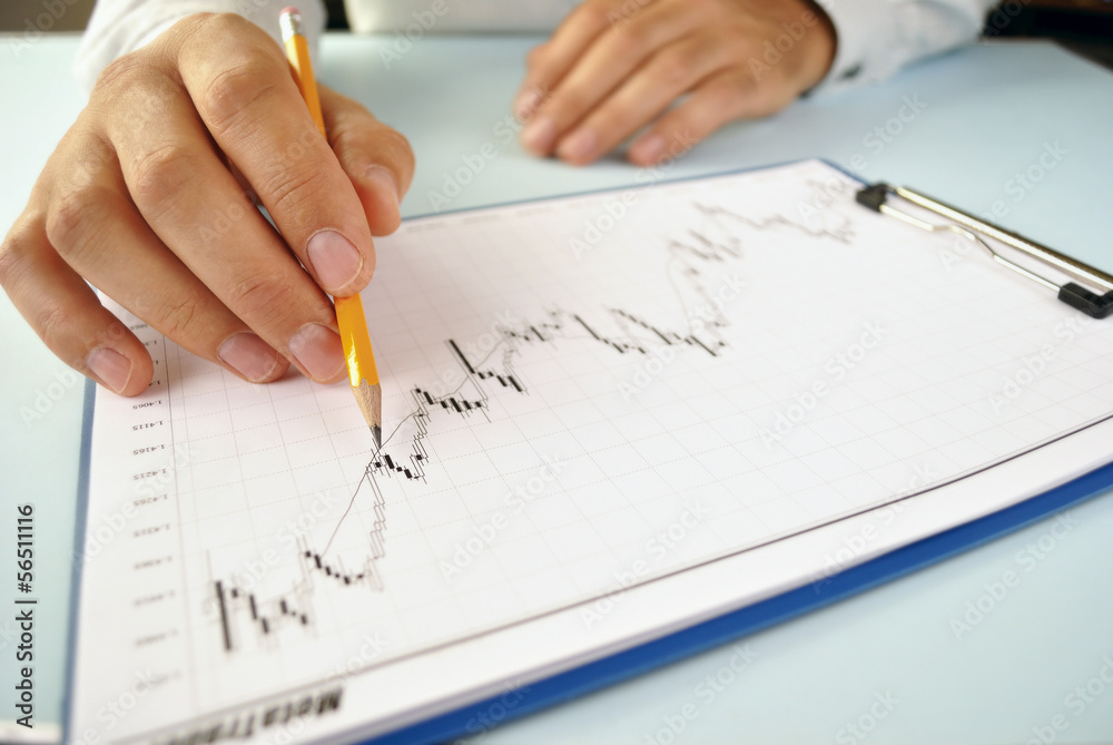 Man analysing an upward trending graph Man analysing an upward trending graph