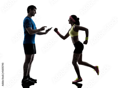 woman exercising jogging man coach using digital tablet
