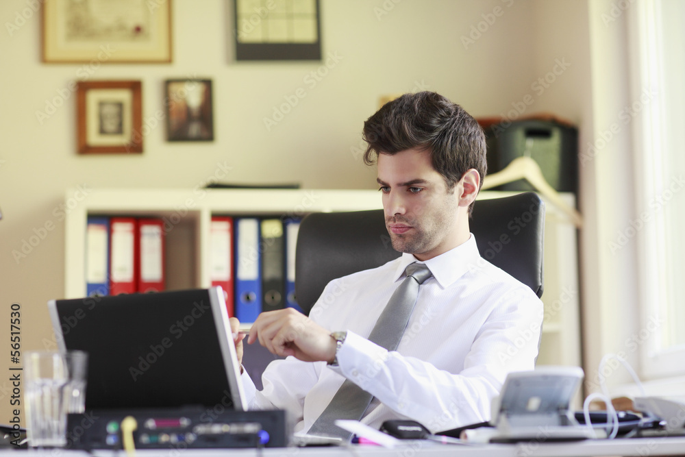 Young businessman working on laptop