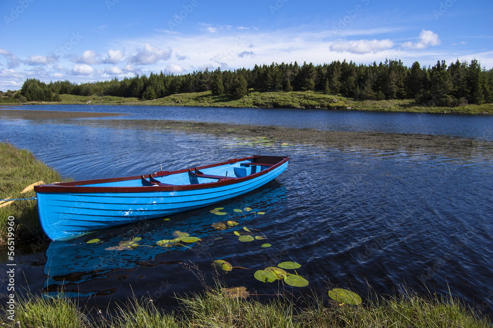 Blue boat in a lake, Connemara Ireland Blue boat in a lake, Connemara Ireland
