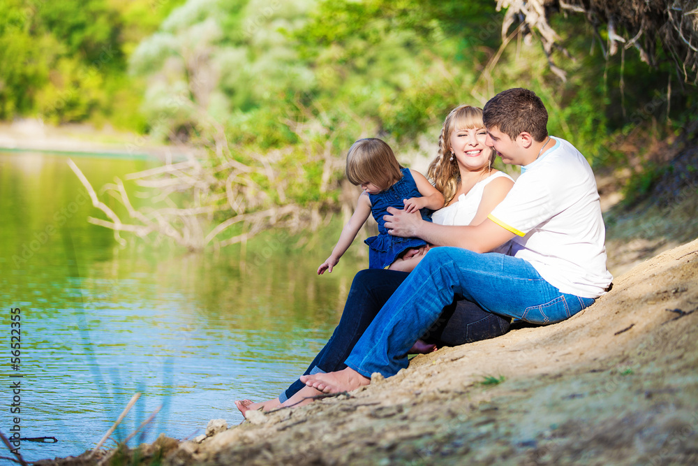 Fototapeta premium happy young family spending time outdoor on a lake