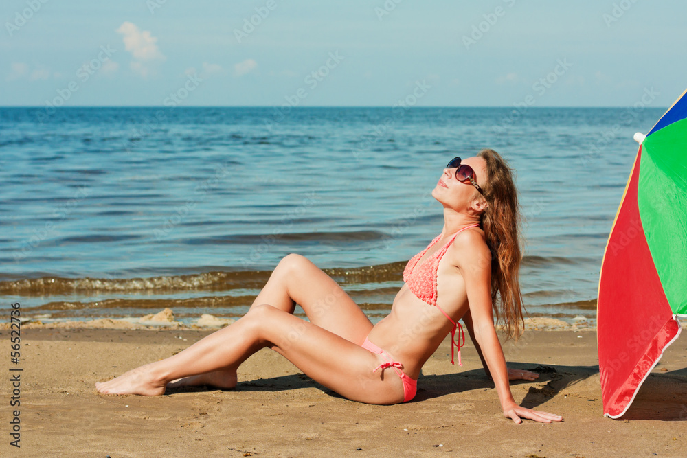 Beautiful woman sunbathing on a beach.