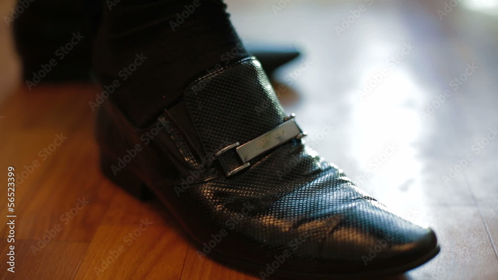 Man putting on his leather shoes. Close-up Man putting on his leather shoes. Close-up