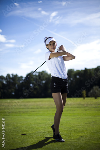 Woman playing golf on field 