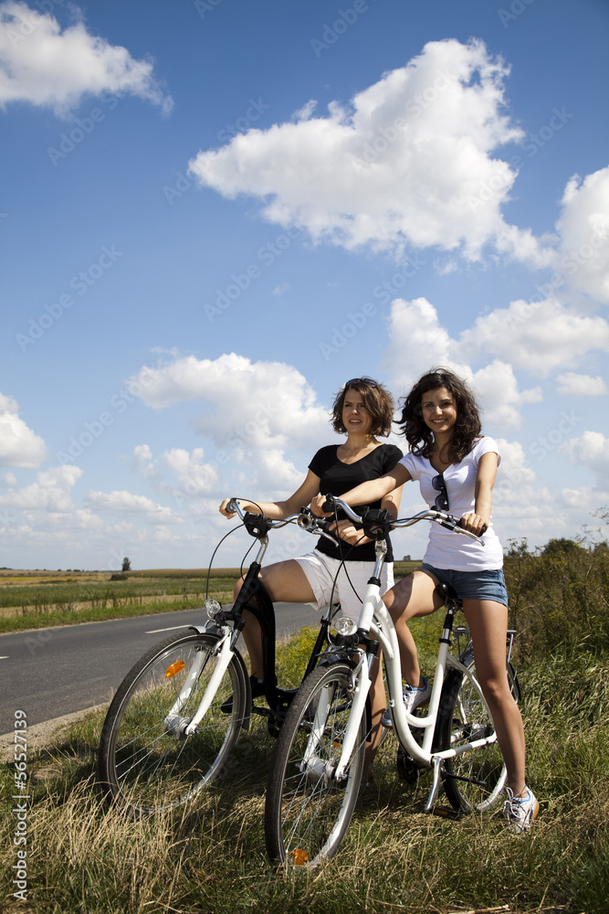 Young girls riding a bicycle 