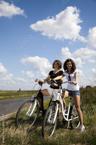 Young girls riding a bicycle 