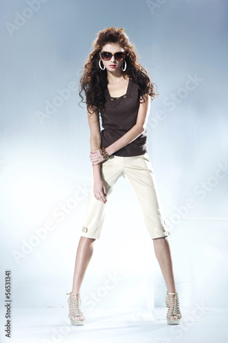 portrait of young woman wearing sunglasses –light background